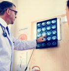 Doctor showing Alzheimer's Brain Scans